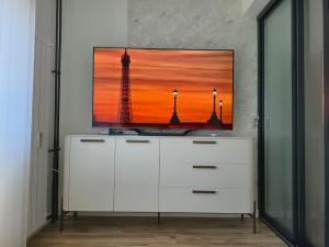 a white dresser with a television on top of it at Negotin Centar Boutique Residence in Negotin