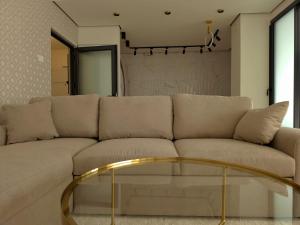 a living room with a couch and a glass table at Negotin Centar Boutique Residence in Negotin