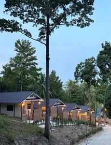 a home with a tree in front of it at PnppGreenhill in Ko Phangan