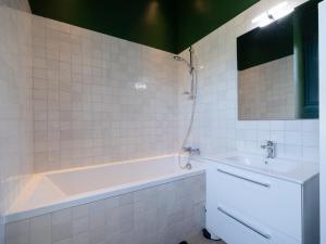 a white bathroom with a tub and a sink at maison savoyarde in Doussard +14 photos
