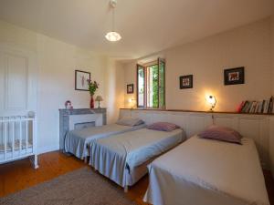 a bedroom with two beds and a fireplace at maison savoyarde in Doussard