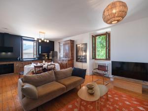 a living room with a couch and a table at maison savoyarde in Doussard
