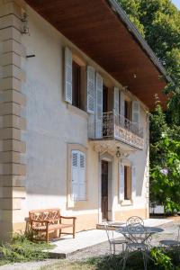 a building with a table and chairs in front of it at maison savoyarde in Doussard
