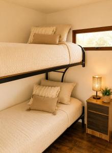 two bunk beds in a small room with a couch at Del sol 2 in La Boca
