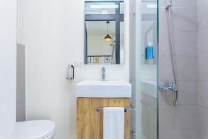 a bathroom with a sink and a toilet and a mirror at Factory Studio in Mar Mikhael in Al Mudawwar