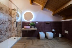 a bathroom with a toilet and a glass shower at The White House in Miglianico +40 photos