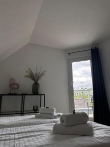 a bedroom with two pillows on a bed with a window at Schönblick Apartments in Schönebeck