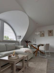 a living room with a couch and a table at Schönblick Apartments in Schönebeck