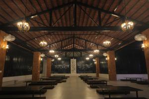 a large room with tables and chairs and chandeliers at Hotel Ashok Vatika in Māharjhari