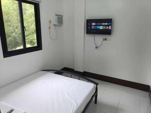 a hospital room with a bed and a window at ljp farm resort couple rooms in Tigaon