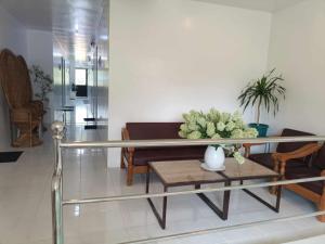 a living room with a table and a couch at ljp farm resort couple rooms in Tigaon
