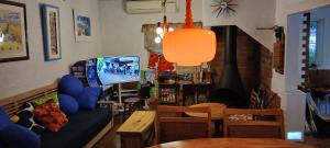 a living room with a couch and a tv at Cafe&ResortInn VAIRGO in Hoki