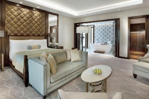 a bedroom with a bed and a couch and a living room at سما تعز in Şīnah