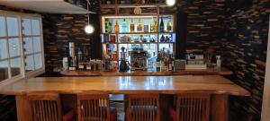 a bar with a wooden table in a room at Cafe&ResortInn VAIRGO in Hoki