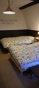 a bed with a colorful comforter in a bedroom at Cafe&ResortInn VAIRGO in Hoki