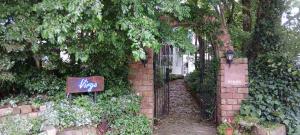 a brick wall with an arch with a sign on it at Cafe&ResortInn VAIRGO in Hoki
