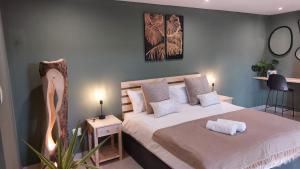 a bedroom with a large bed with white sheets at Guesthouse Charis in Pretoria