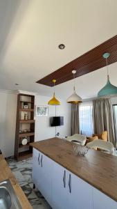 a kitchen with pendant lights and a counter top at Yolaan Guesthouse in Sterkspruit