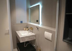 a bathroom with a sink and a mirror at Aeon Blue in Selianitika +38 photos