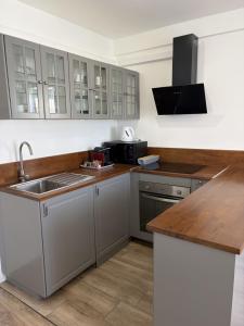 a kitchen with a sink and a microwave at Hôtel The Originals Miramar, Royan Pontaillac in Royan +50 photos