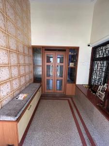 a room with a bench in front of a door at DIVINE GRACE Homestay in Udupi
