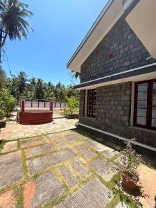 a house with a stone walkway in front of it at DIVINE GRACE Homestay in Udupi