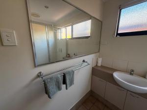 a bathroom with a sink and a mirror at Broome Rest House in Broome
