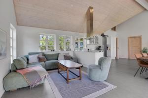 a living room with a couch and a table at Feriehus 1150 in Ringkøbing