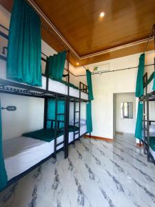 a room with three bunk beds and a tile floor at Snooze hostel lombok in Selong Belanak