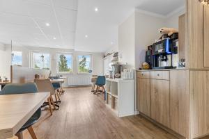 a kitchen and dining room with a table and chairs at Hotel Norden Norddeich in Norddeich