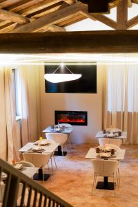 a dining room with tables and a fireplace at Alnus in Valentano