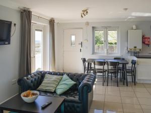a living room with a couch and a table at Ivy No1 - Uk49251 in Althorne