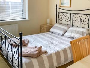 a bedroom with a black bed with white sheets and a window at Thistle No4 - Uk49250 in Althorne