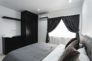 a bedroom with a bed and a window at The One Apartment in Rawai Beach