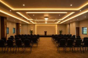 a conference room with chairs and a podium in the middle at Prakruthi Retreat Belagavi in Belgaum
