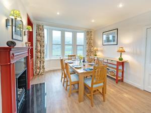 a kitchen and dining room with a table and chairs at Pinclanty Cottage in Pinmore +13 photos