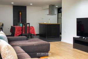 a living room with a couch and a table at Quinta do Moinho in Castelo de Paiva