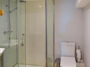 a bathroom with a toilet and a glass shower at Holly No2 - Uk49254 in Althorne