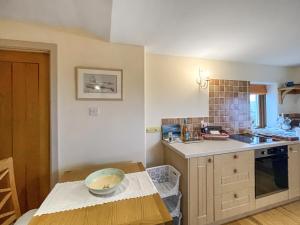 a kitchen with a table with a bowl on it at Bothan Aonghais in Portree