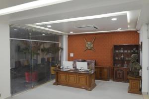 a room with a desk and a statue on a wall at Hotel Ashok Vatika in Māharjhari