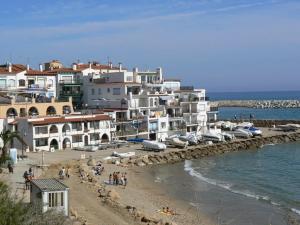 a group of buildings on a beach next to the water at Casa en el Roc de Sant Gaieta in Roda de Bará