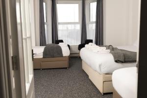 a room with two beds and a window at STAYtastic in Lowestoft
