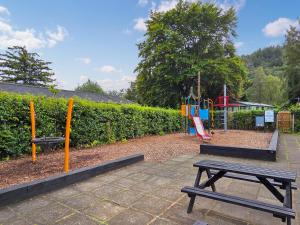 a playground with a picnic table and a swing at 1 Sunview Garden in Birnam +21 photos