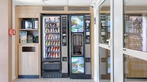 a convenience store with two soda vending machines at Premiere Classe Dreux in Dreux