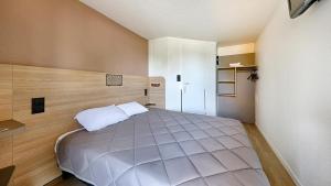 a bedroom with a large bed in a room at Premiere Classe Dreux in Dreux