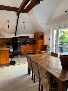 a large kitchen with a wooden table and chairs at Apartament Morgan in Mieroszyno