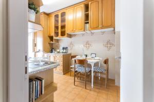 a kitchen with wooden cabinets and a table and chairs at Casa Giordano in Rome