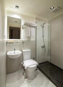 a bathroom with a toilet and a sink and a shower at The Avenue in El Alamein +33 photos