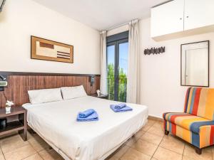 a bedroom with a bed and a desk and a chair at Apartment Alamar by Interhome in La Cala de Mijas