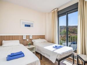 a hospital room with two beds and a window at Apartment Alamar by Interhome in La Cala de Mijas
